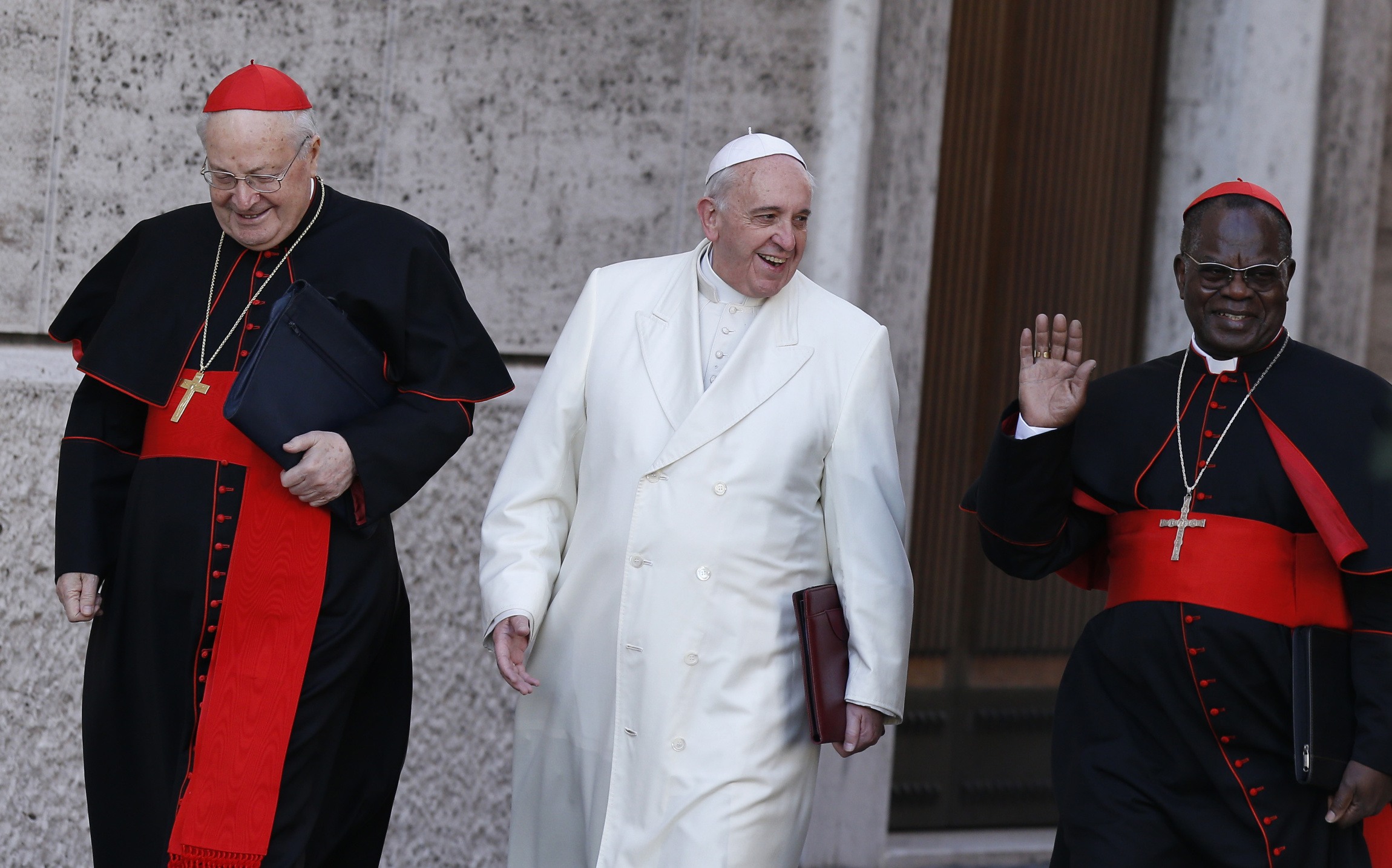 Pope Francis walks with Cardinals Sodano and Monsengwo as he arrives to lead meeting of cardinals in synod hall at Vatican
