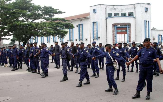 Riot policemen parade before blocking demonstrators during a protest against President Joseph Kabila organized by the Catholic church in Kinshasa